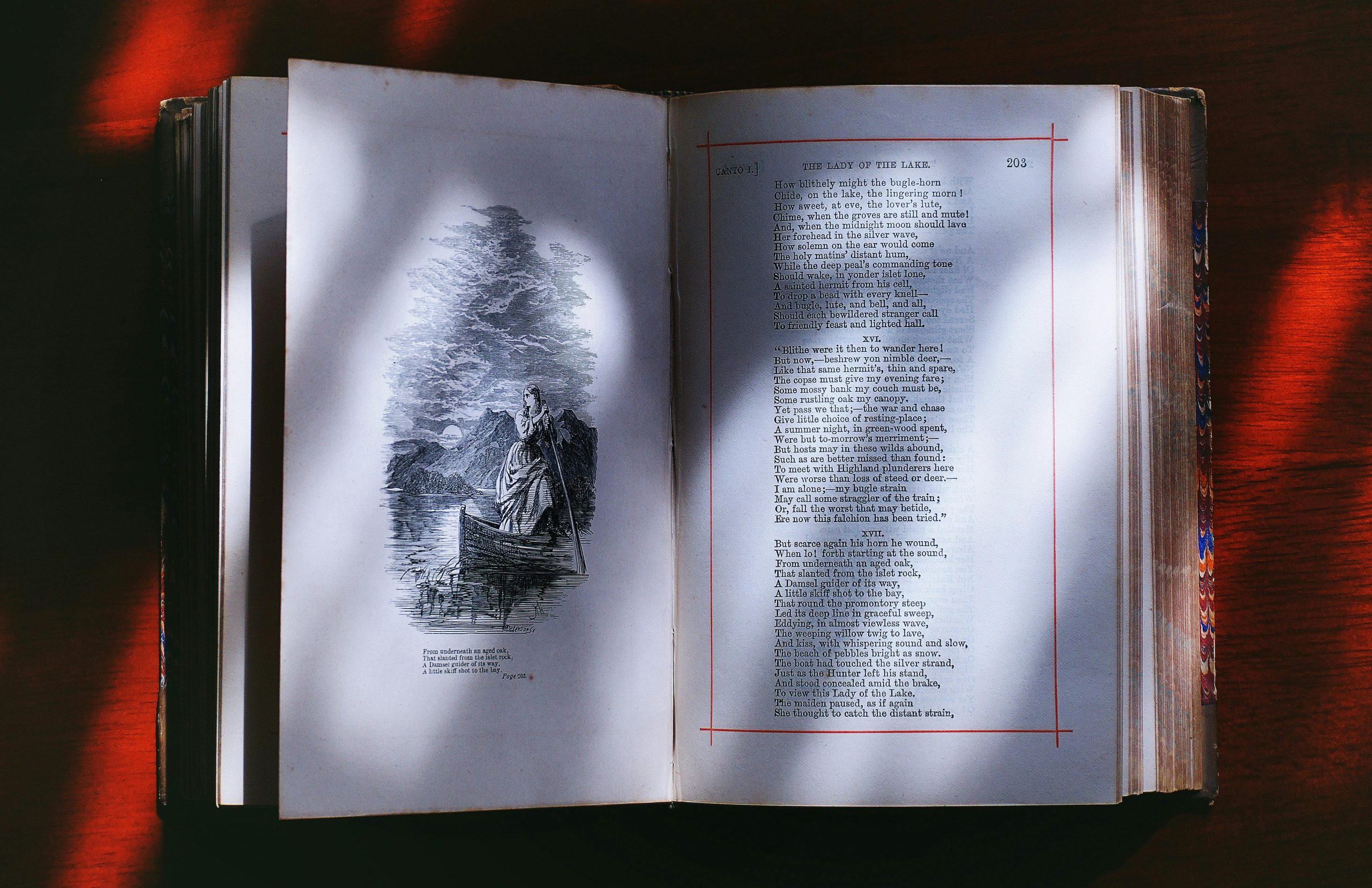 An open vintage book displaying illustrated poetry pages, creating an artistic literary ambiance.